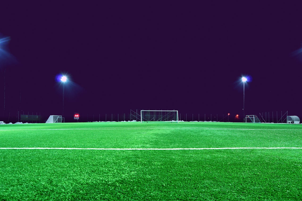 Home A brightly lit soccer field at night in Norrtälje, Sweden, showcasing green turf and stadium lights.